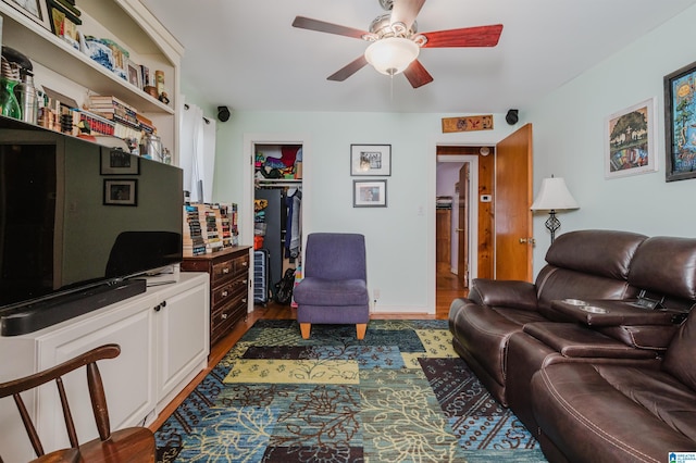 living room with wood finished floors and ceiling fan