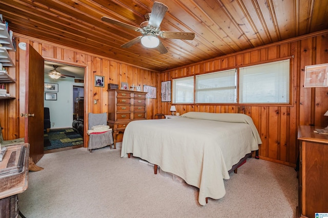 bedroom featuring wooden ceiling, wooden walls, and light colored carpet