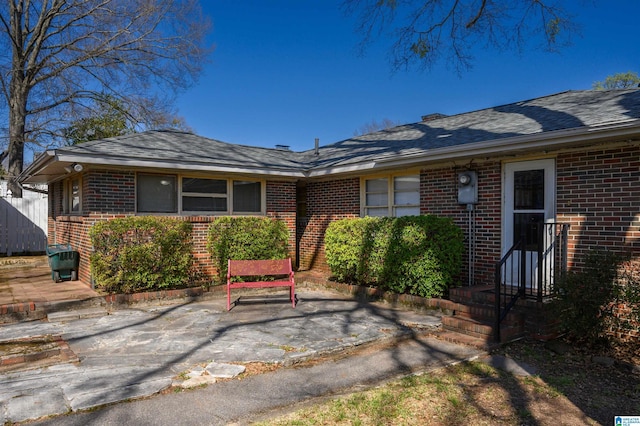 back of property featuring brick siding