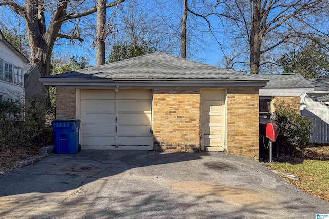 garage featuring concrete driveway