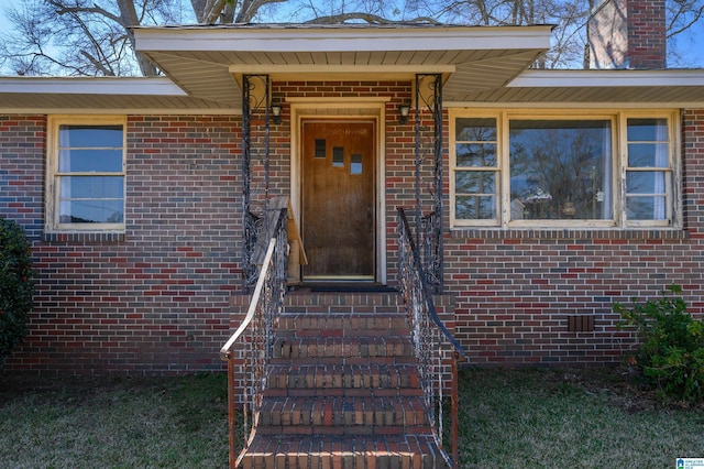 property entrance featuring brick siding