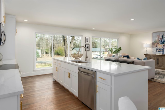 kitchen with wood finished floors, white cabinetry, recessed lighting, a sink, and stainless steel dishwasher