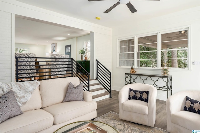 living room with stairway, baseboards, a ceiling fan, and wood finished floors