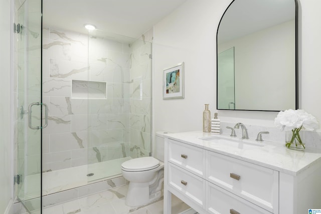 bathroom with marble finish floor, a stall shower, toilet, and vanity