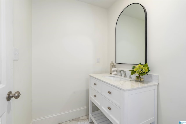 bathroom with vanity and baseboards