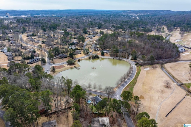 birds eye view of property featuring a wooded view and a water view