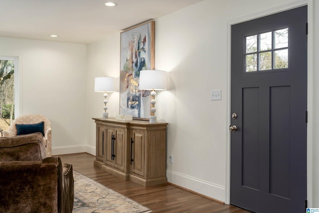 entrance foyer with a wealth of natural light, baseboards, and wood finished floors