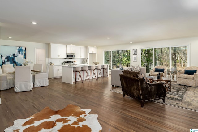 living area featuring recessed lighting and dark wood-style floors