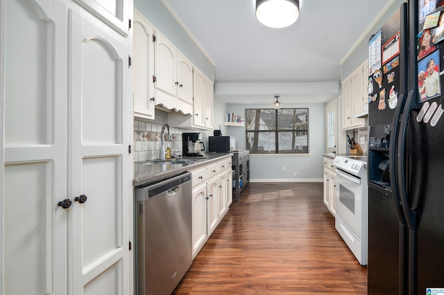 kitchen featuring dishwasher, electric stove, black fridge, white cabinetry, and a sink