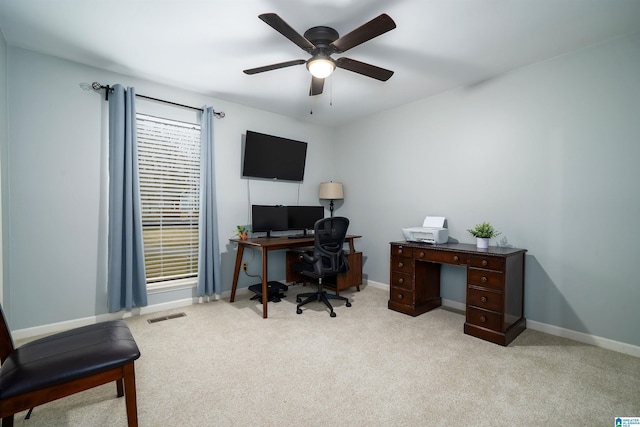 office featuring baseboards, visible vents, ceiling fan, and carpet flooring