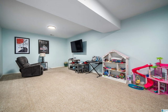 rec room with carpet and baseboards