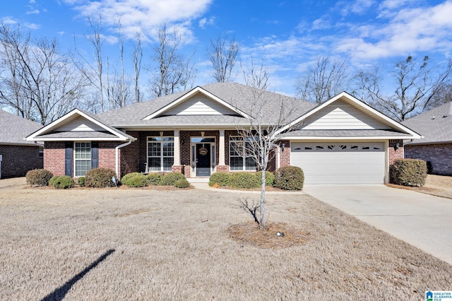 ranch-style home featuring driveway, an attached garage, a shingled roof, and brick siding