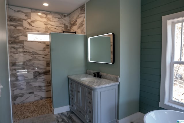 bathroom with a wealth of natural light, walk in shower, and vanity