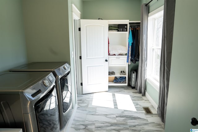 washroom featuring visible vents, marble finish floor, washer and dryer, baseboards, and laundry area