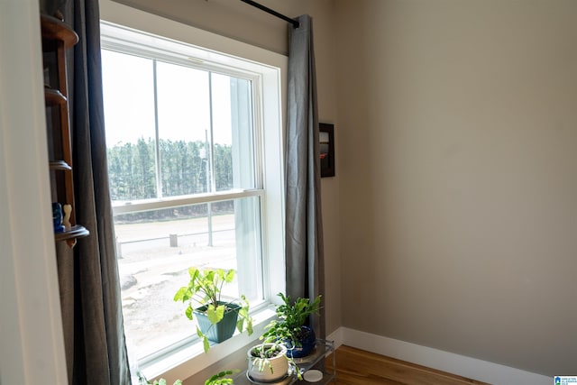 interior space featuring baseboards and wood finished floors