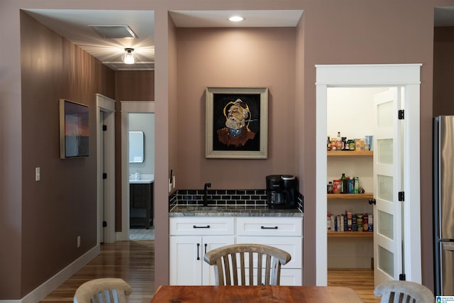 interior space featuring light wood-style flooring and baseboards