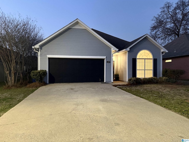 ranch-style house with an attached garage and concrete driveway