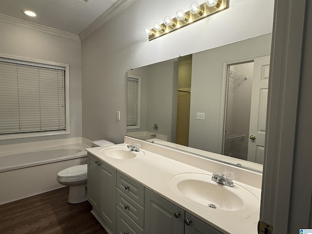 bathroom featuring a garden tub, a sink, and toilet