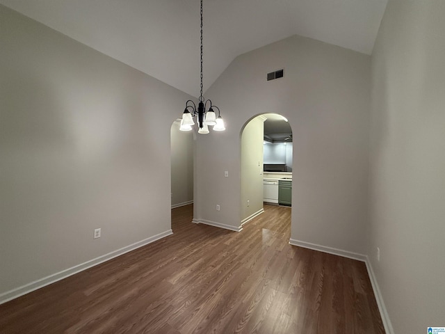 unfurnished dining area featuring baseboards, visible vents, arched walkways, lofted ceiling, and dark wood-style flooring