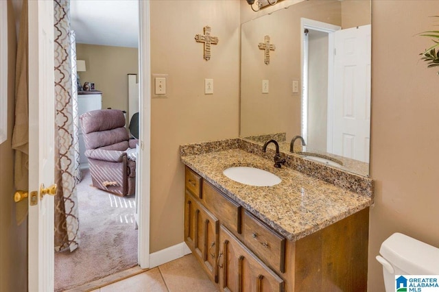 half bathroom with vanity, toilet, and tile patterned floors