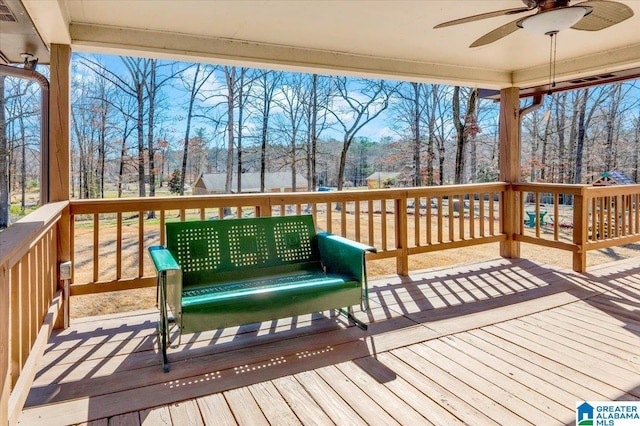 wooden terrace featuring visible vents and ceiling fan