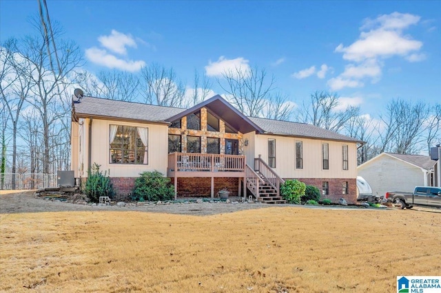 view of front of home with a front yard and stairs