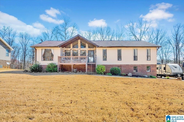 view of front of home with brick siding and a front yard