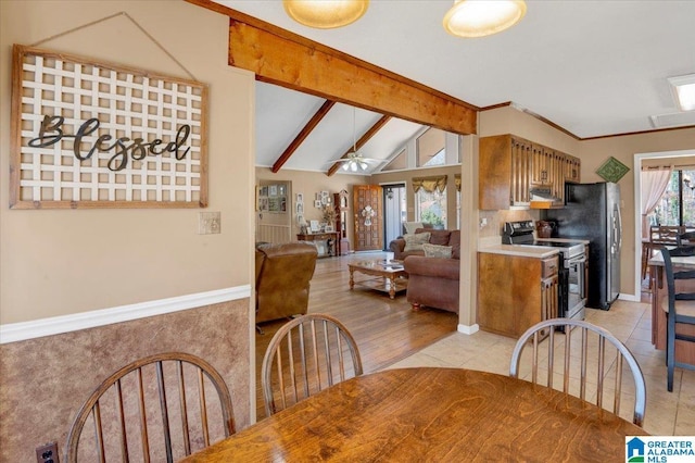 dining area with lofted ceiling with beams, ceiling fan, and light tile patterned floors