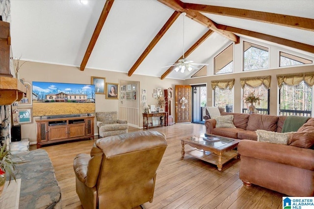 living room with light wood-type flooring, plenty of natural light, and high vaulted ceiling