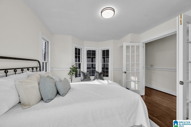 bedroom featuring french doors and wood finished floors