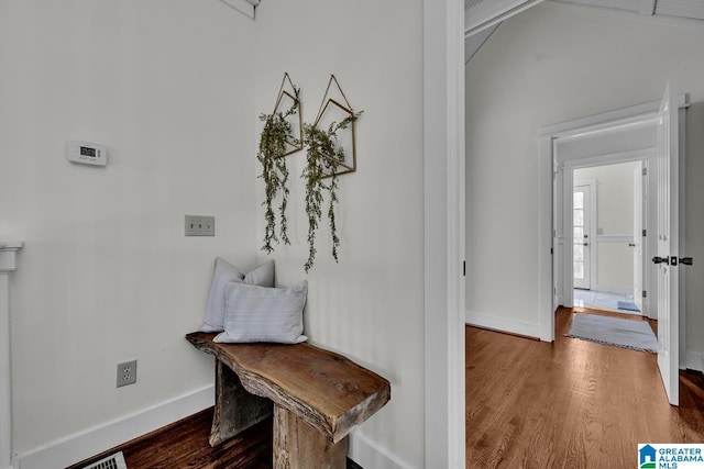 interior space with baseboards and wood finished floors