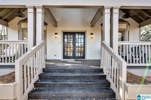 entrance to property with a porch and french doors