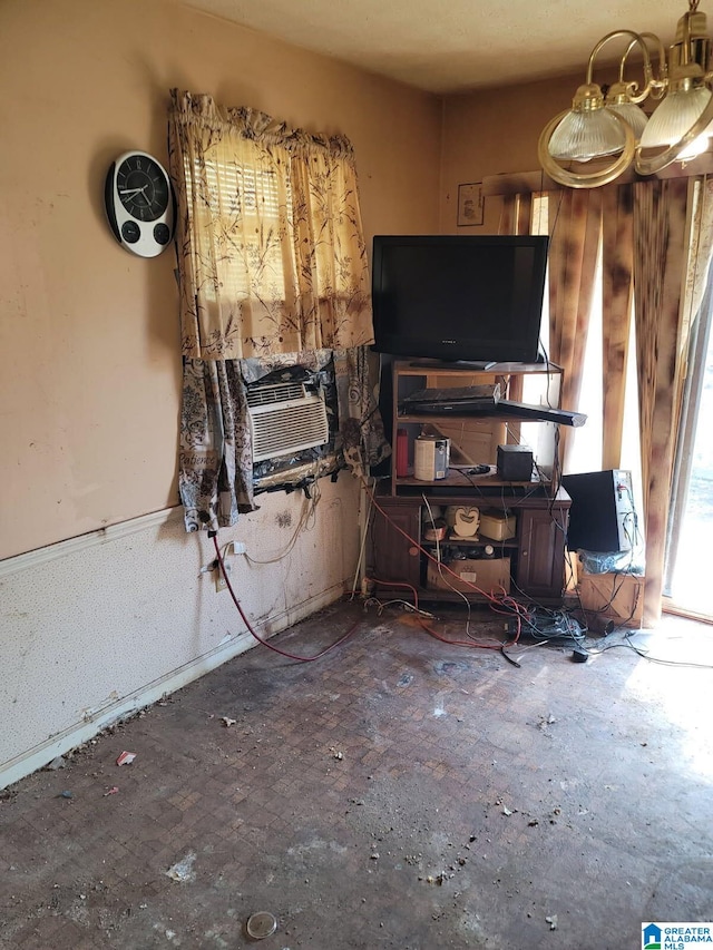 living room with cooling unit and wainscoting