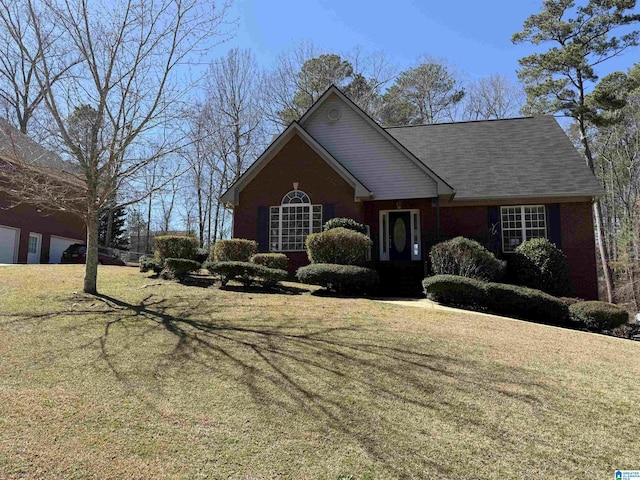 traditional-style home featuring a front yard and brick siding