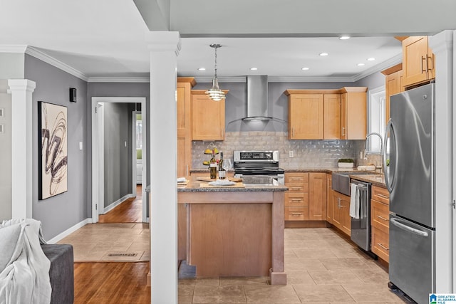 kitchen with stone countertops, appliances with stainless steel finishes, ornate columns, light brown cabinetry, and wall chimney range hood