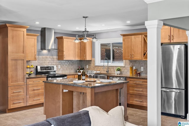 kitchen featuring a sink, appliances with stainless steel finishes, wall chimney range hood, ornamental molding, and a center island