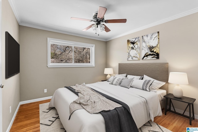 bedroom with baseboards, ornamental molding, ceiling fan, and wood finished floors