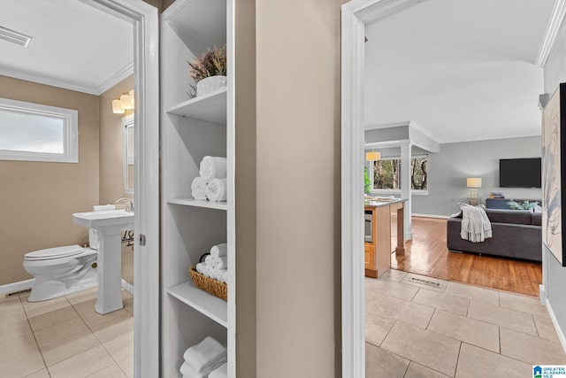 half bath featuring ornamental molding, tile patterned flooring, visible vents, and toilet