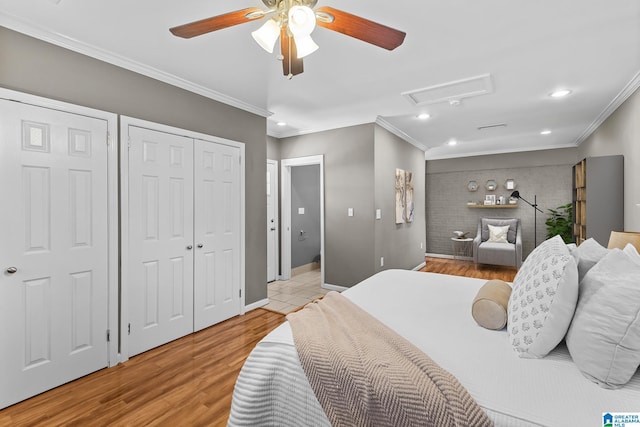 bedroom with attic access, baseboards, ornamental molding, and light wood finished floors