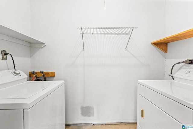 washroom featuring laundry area and washing machine and clothes dryer