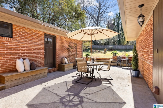 view of patio / terrace featuring outdoor dining area and fence