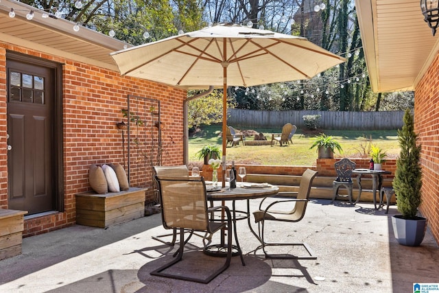 view of patio / terrace featuring fence and outdoor dining area