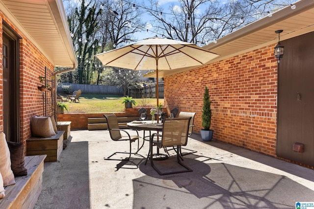 view of patio with fence and outdoor dining space