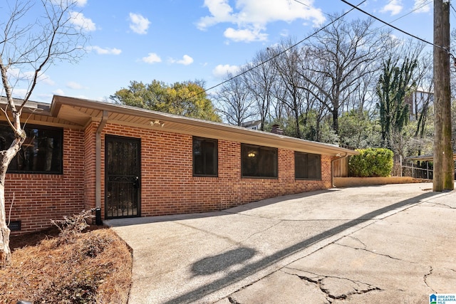 view of front of home with concrete driveway and brick siding