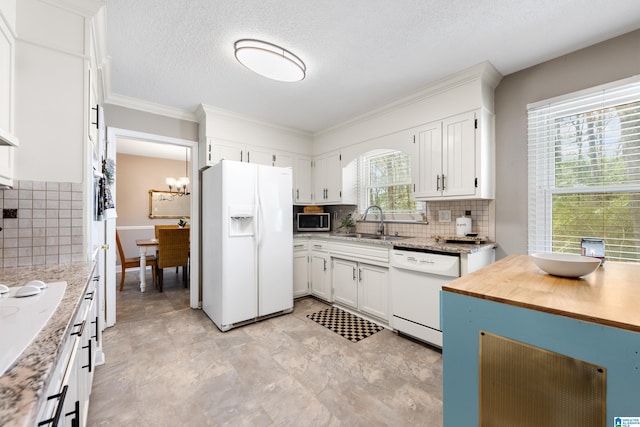 kitchen with backsplash, white cabinetry, a sink, a textured ceiling, and white appliances