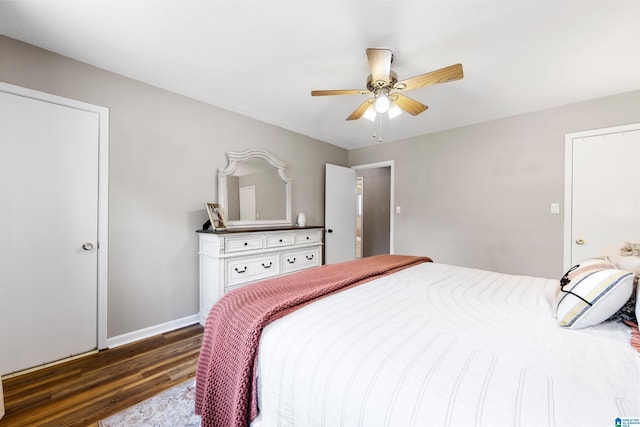 bedroom with ceiling fan, baseboards, and wood finished floors