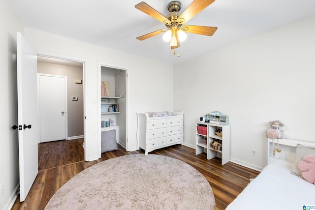 bedroom with a ceiling fan, baseboards, and dark wood-style flooring