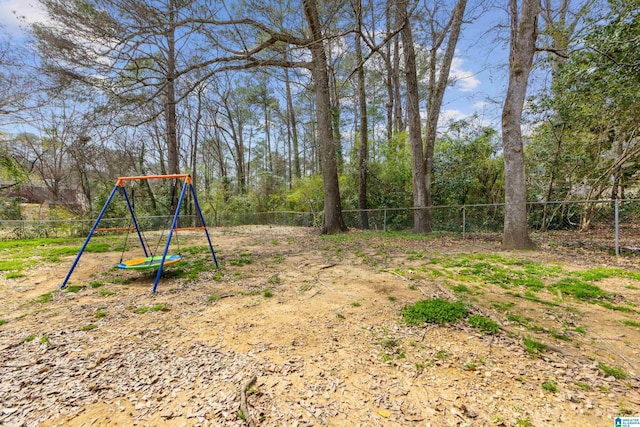 view of yard with a playground and fence