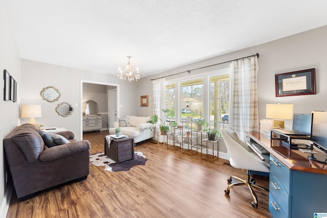 interior space with an inviting chandelier, a textured ceiling, and wood finished floors