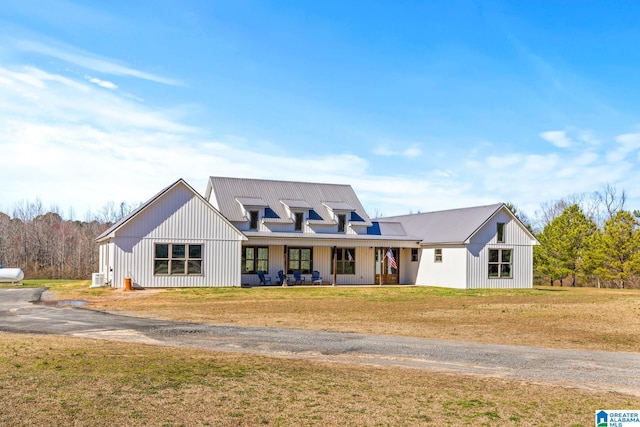 modern farmhouse style home with a front yard